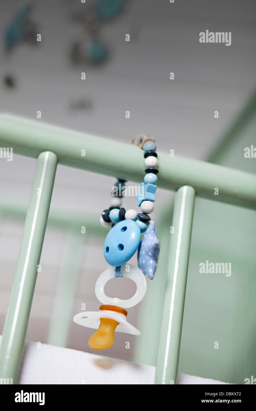 Baby's Pacifier Hanging On Baby Crib, Munich, Bavaria, Germany Stock Photo