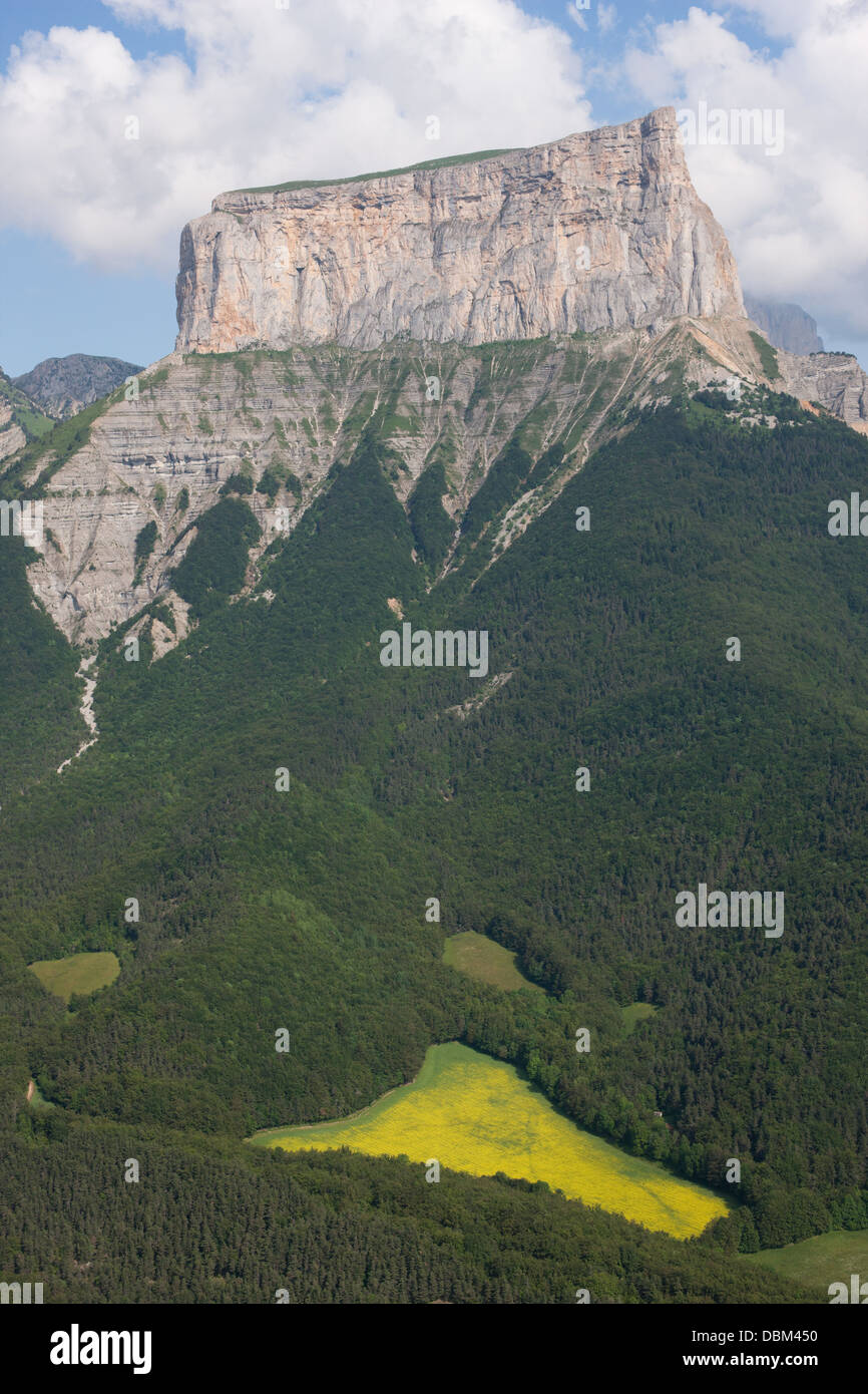 AERIAL VIEW. Lofty (elevation: 2087 meters asl) isolated limestone butte in the Vercors Mountains. Mont Aiguille, Isere, France. Stock Photo