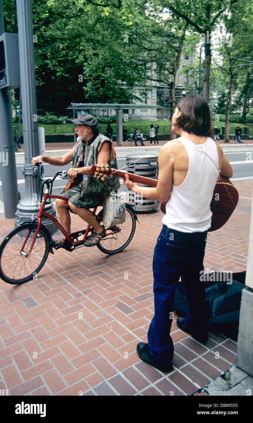 street performer plays guitar on Portland Oregon street Stock Photo