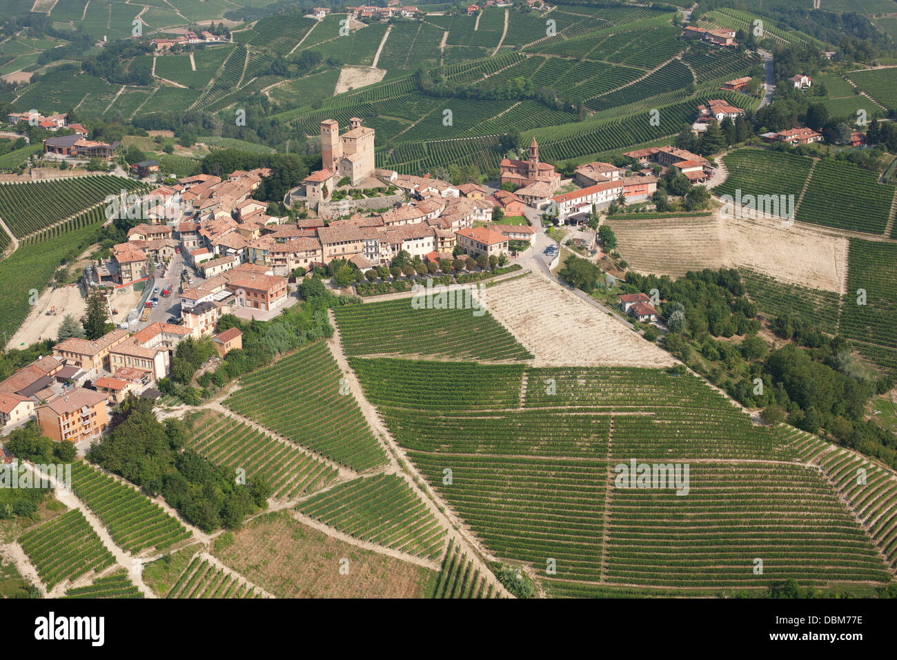 AERIAL VIEW. Medieval hilltop village surrounded by grapevines in the Langhe region. Serralunga d'Alba, Province of Cuneo, Piedmont, Italy. Stock Photo