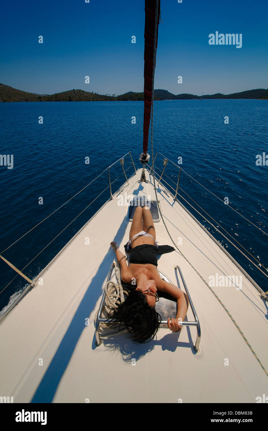Young woman sunbathing on yacht hi-res stock photography and images - Alamy