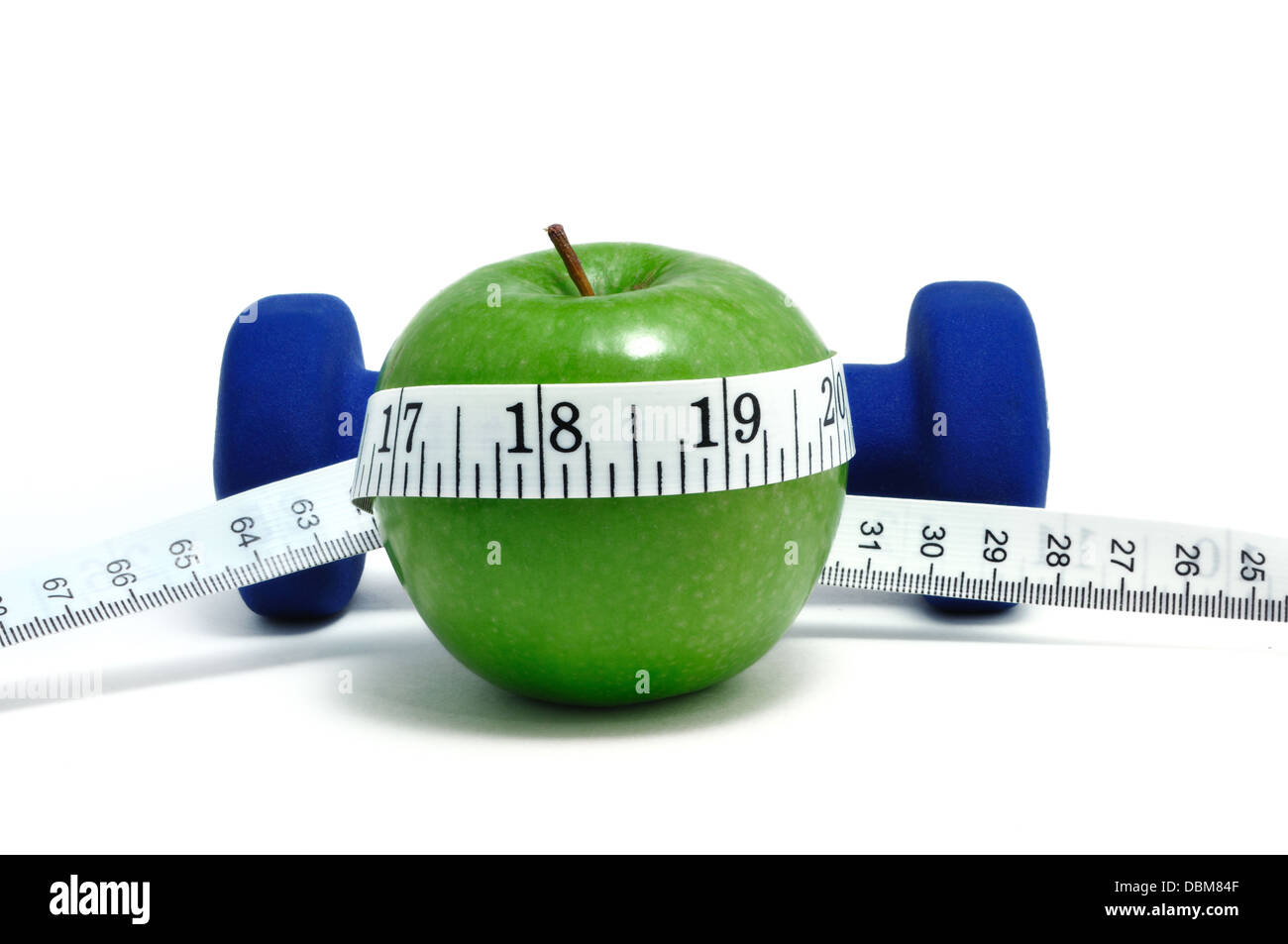 Dieting concept - weights / dumbbells, tape measure and apple Stock Photo