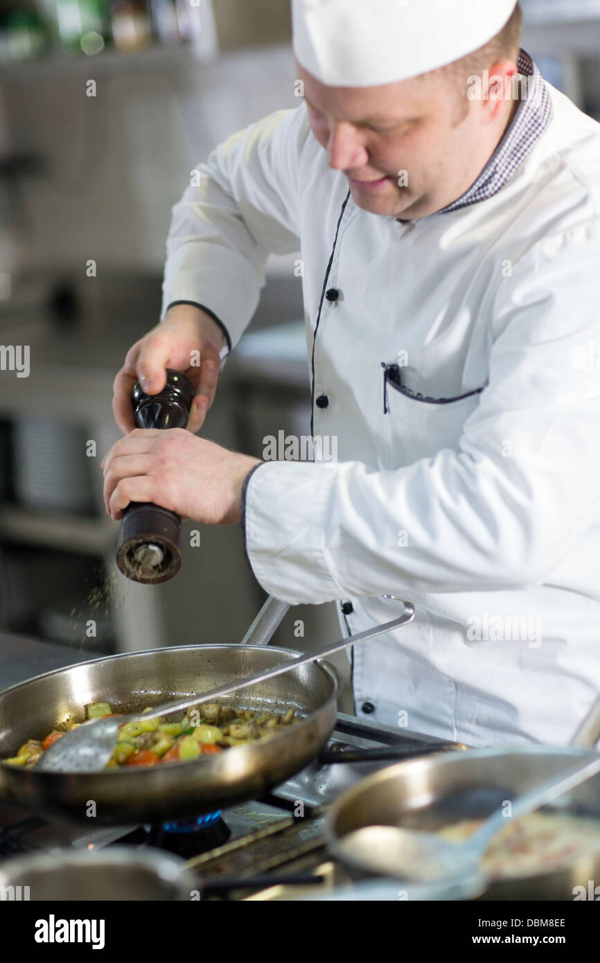 Chef Seasoning Food In Pan Stock Photo Alamy