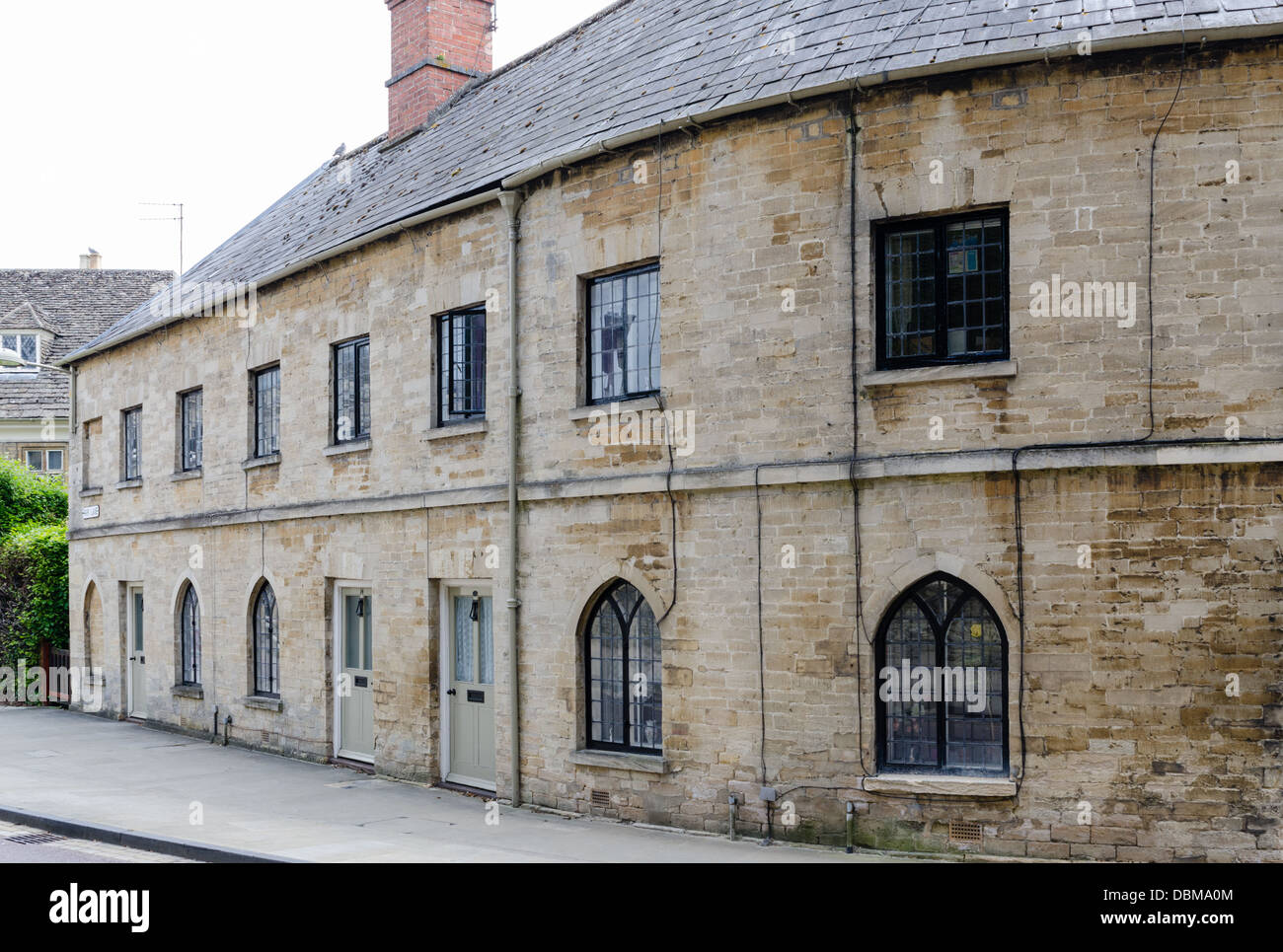 Row of traditional Cotswold stone terraced houses on a corner in Park Lane, Cirencester Stock Photo