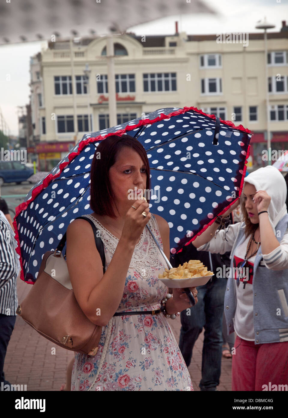 Eating chips on a rainy day in Brighton Stock Photo Alamy