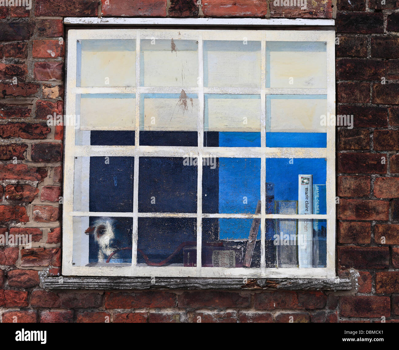 Painted window tromp l'oeil depicting a pet dog indoors. Stock Photo