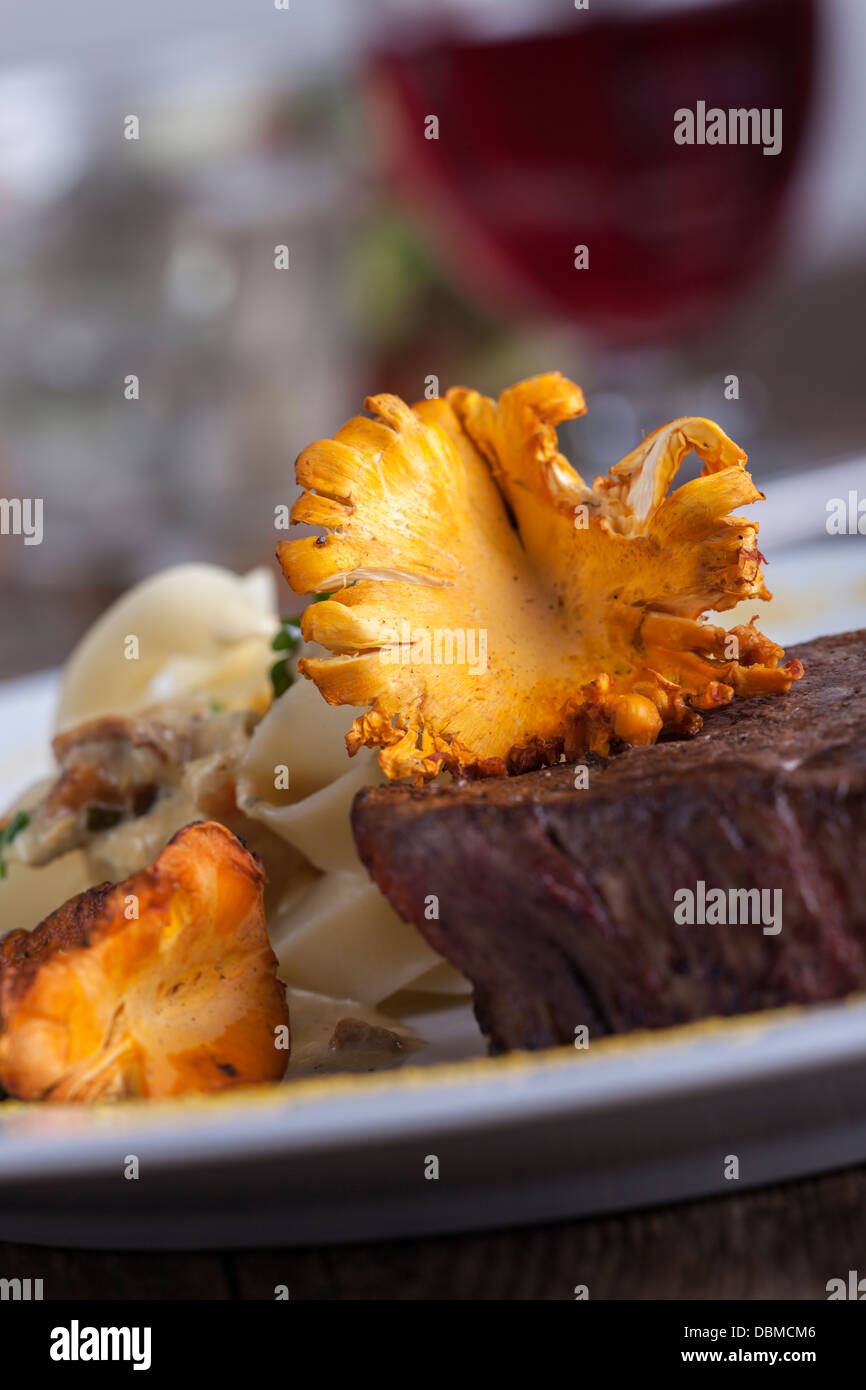 steak with chanterelle mushroom and noodles Stock Photo Alamy