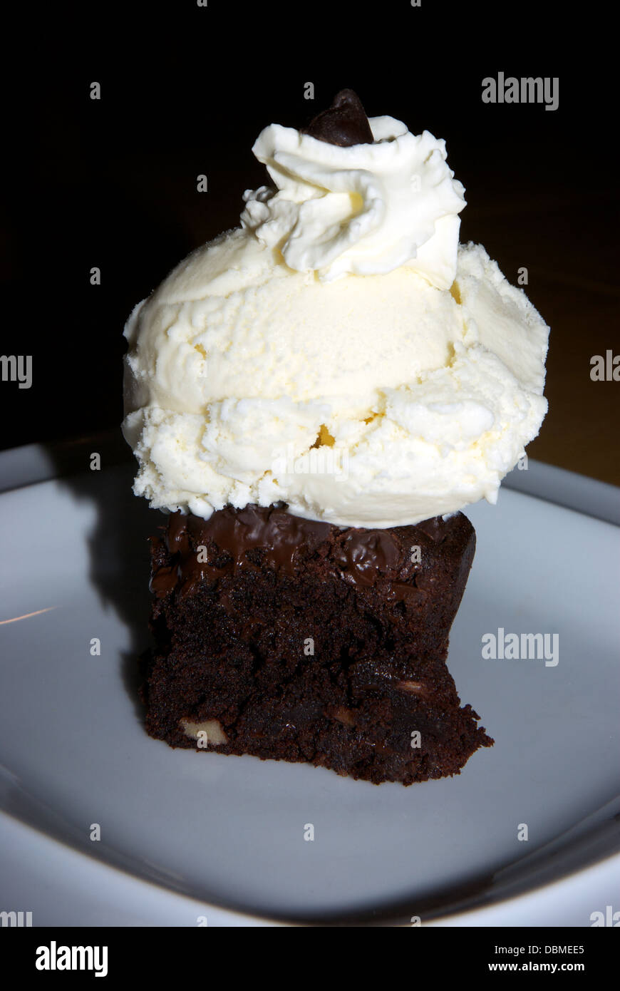 Baked chocolate chip brownie scoop vanilla ice cream whipped cream