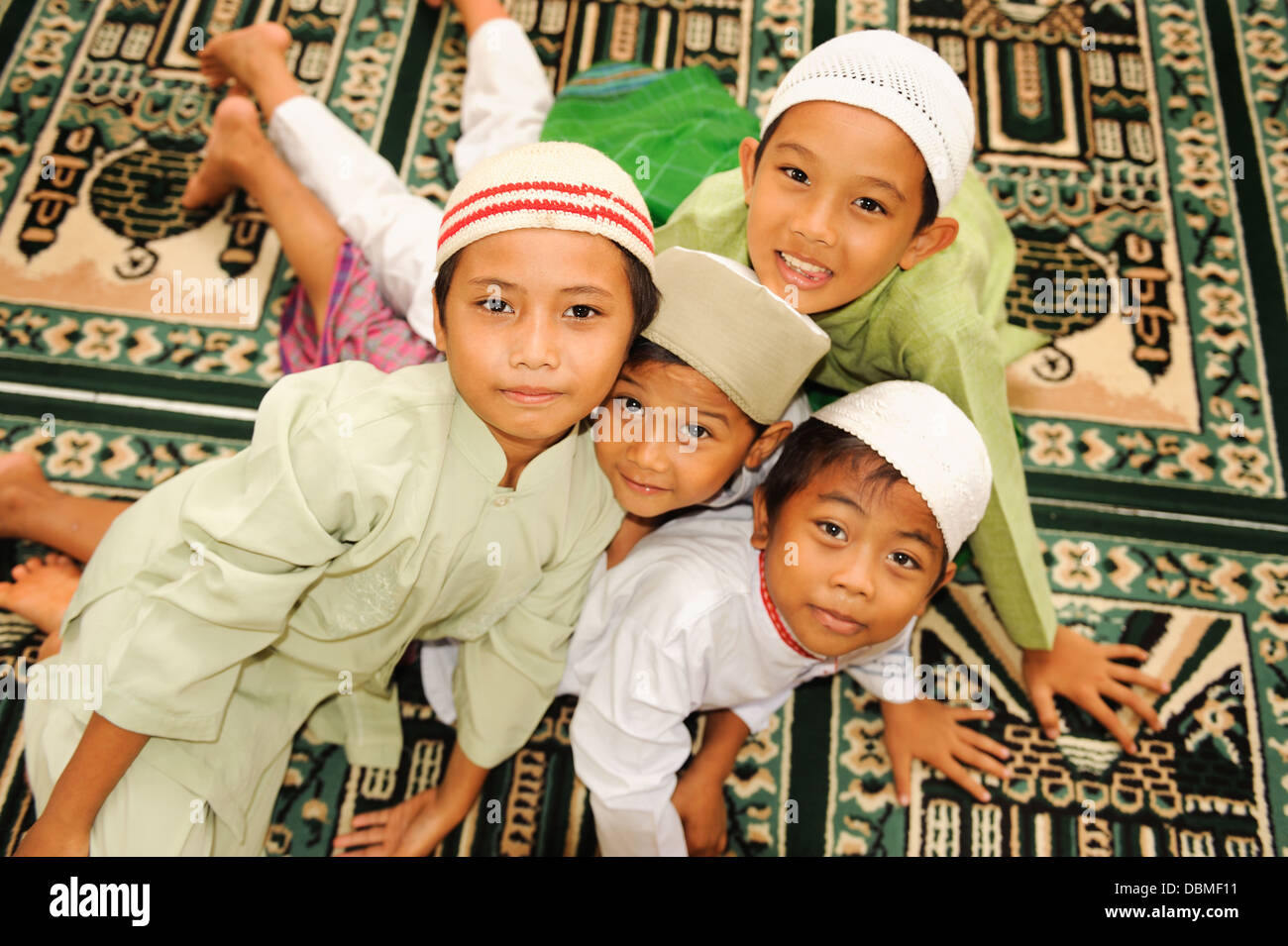 Muslim kids holding hands in a Mosque Stock Photo