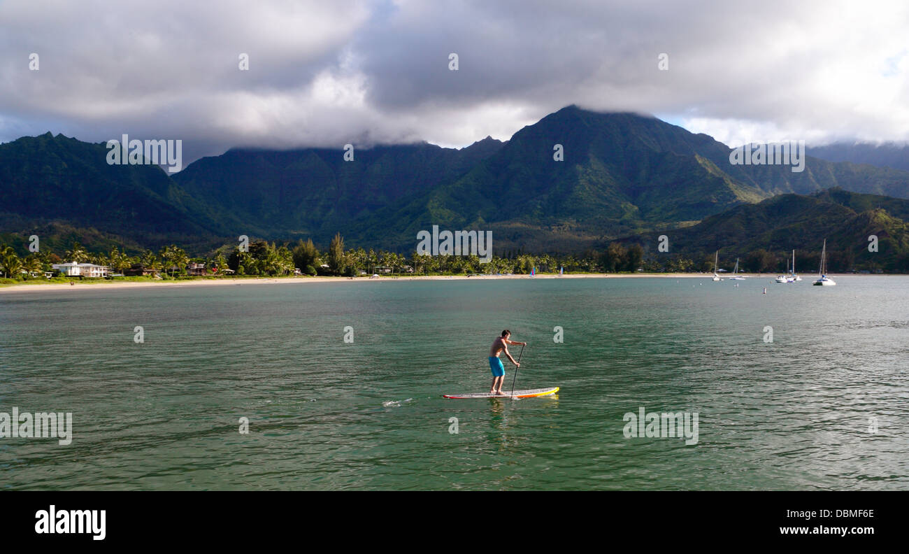Stand up paddleboarder in Hanalei Bay on Kauai at sunset Stock Photo