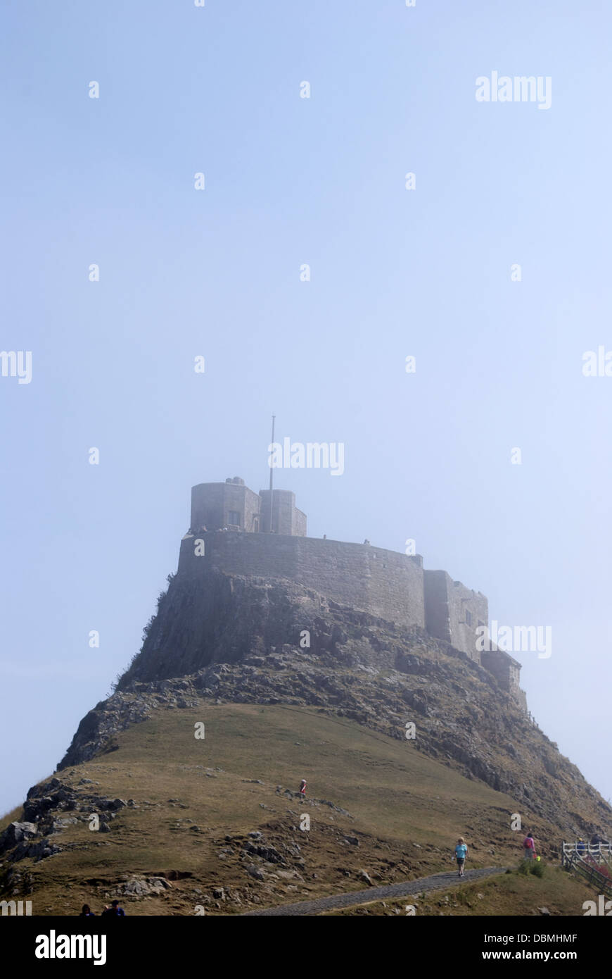Misty view looking up at the castle on holy island Stock Photo