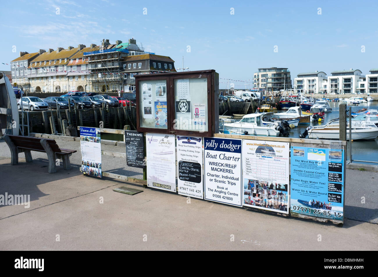 Signs and posters advertising fishing and pleasure trips at West Bay  Harbour Dorset UK Stock Photo - Alamy