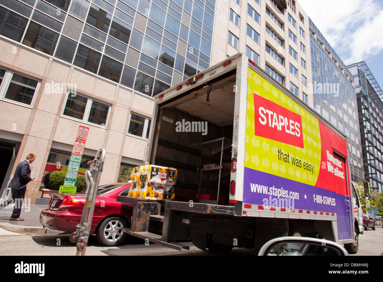 Staples delivery truck parked in front of office building Stock Photo