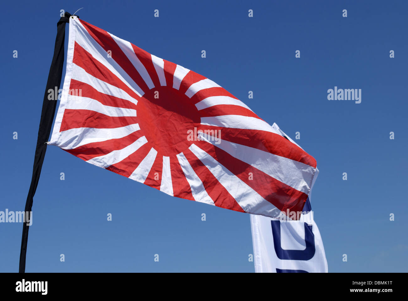 japanese flag waving on blue sky Stock Photo