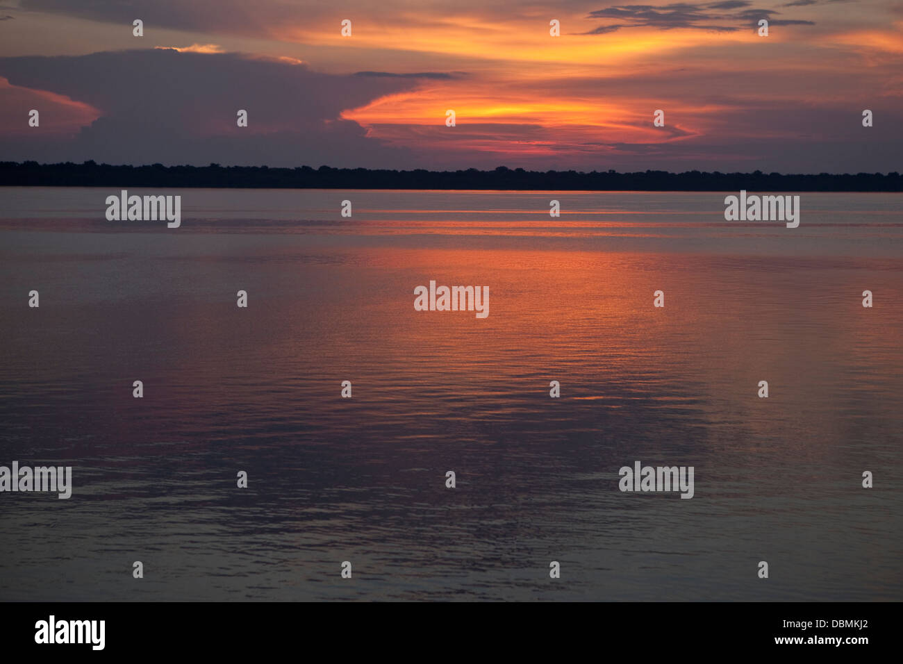 Orange calm sunset on the Rio Negro in the Amazon River basin Brazil. Stock Photo