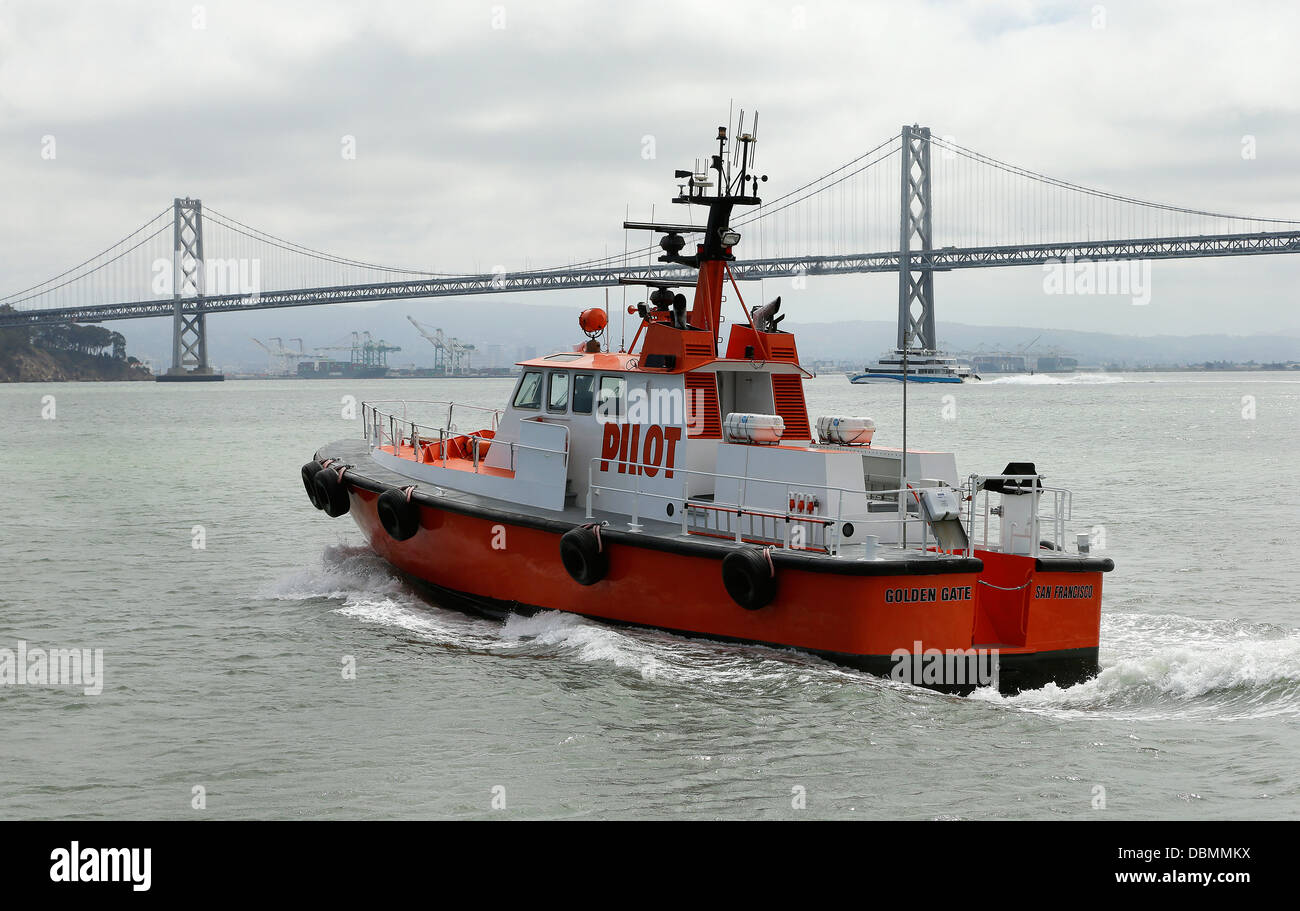 San Francisco Bay Bar Pilot boat heads out onto SF Bay near the San Francisco Oakland Bay Bridge Stock Photo