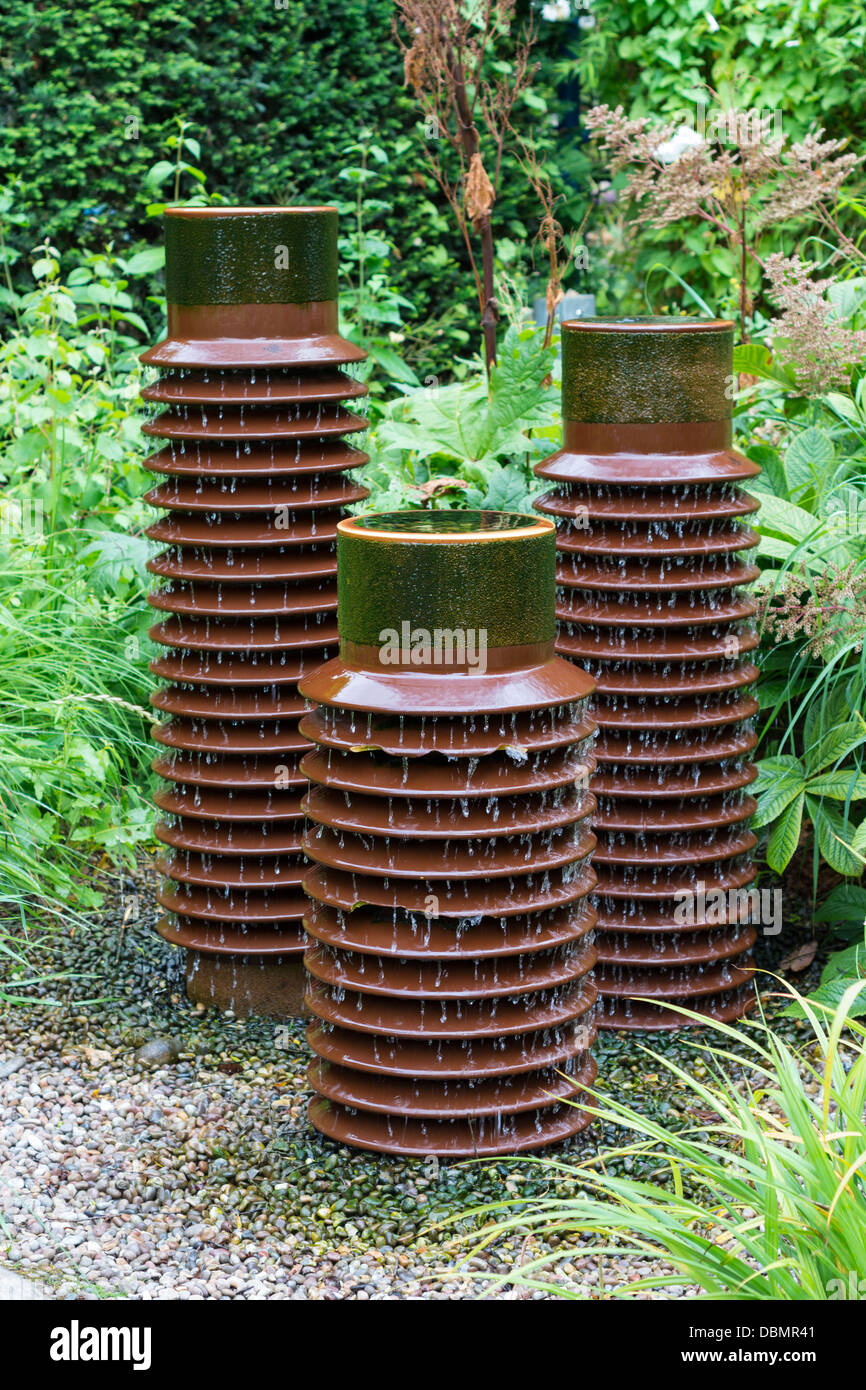 Water feature constructed from industrial electrical insulators, Kim Wilde Richard Holmes, ' a lifetime ahead' garden, Springfie Stock Photo