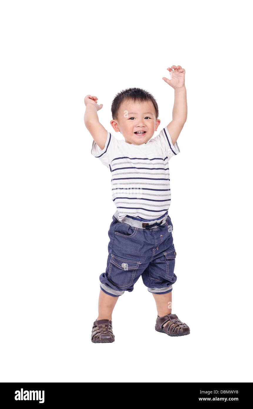 Little boy stand and raise hands up Stock Photo