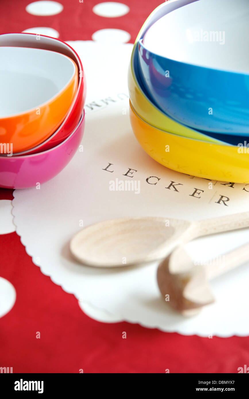 Bowls and wooden spoons on place mat, Munich, Bavaria, Germany Stock Photo