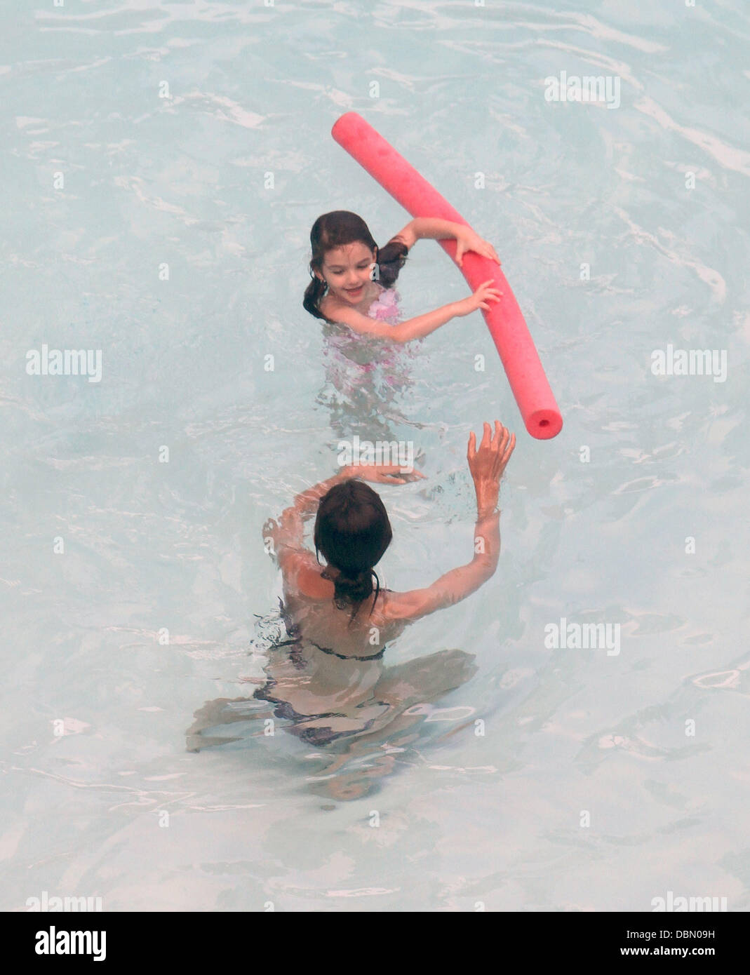 Suri Cruise and her mother Katie Holmes swimming and playing games in(02)
