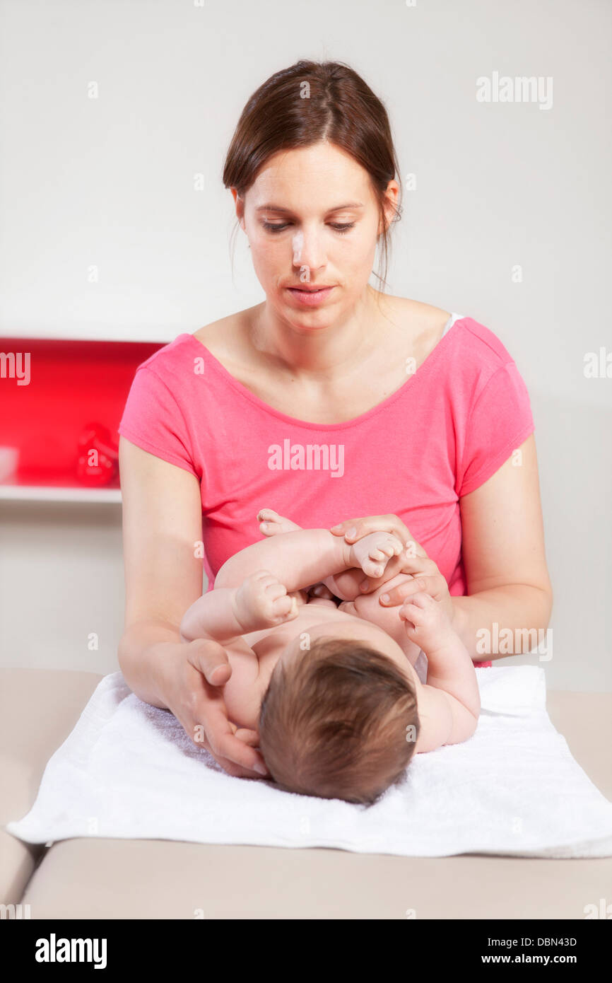 Baby boy receiving treatment from female osteopath, Munich, Bavaria, Germany Stock Photo