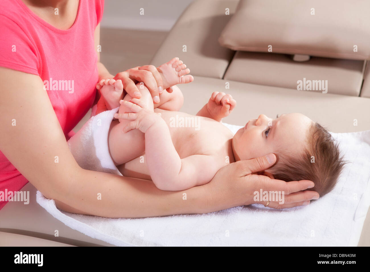 Baby boy receiving treatment from female osteopath, Munich, Bavaria, Germany Stock Photo