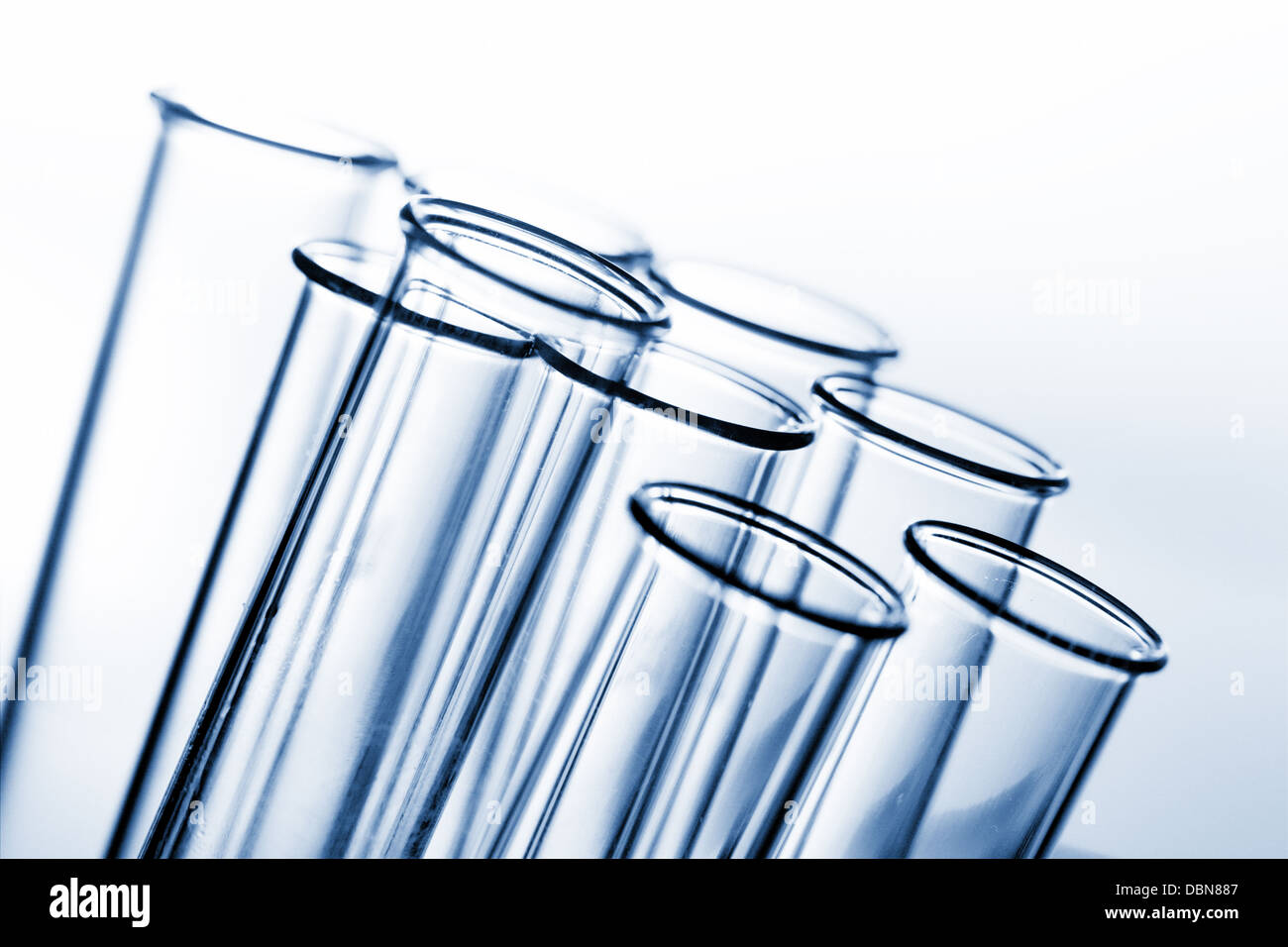 glass test tubes on a blue background Stock Photo - Alamy
