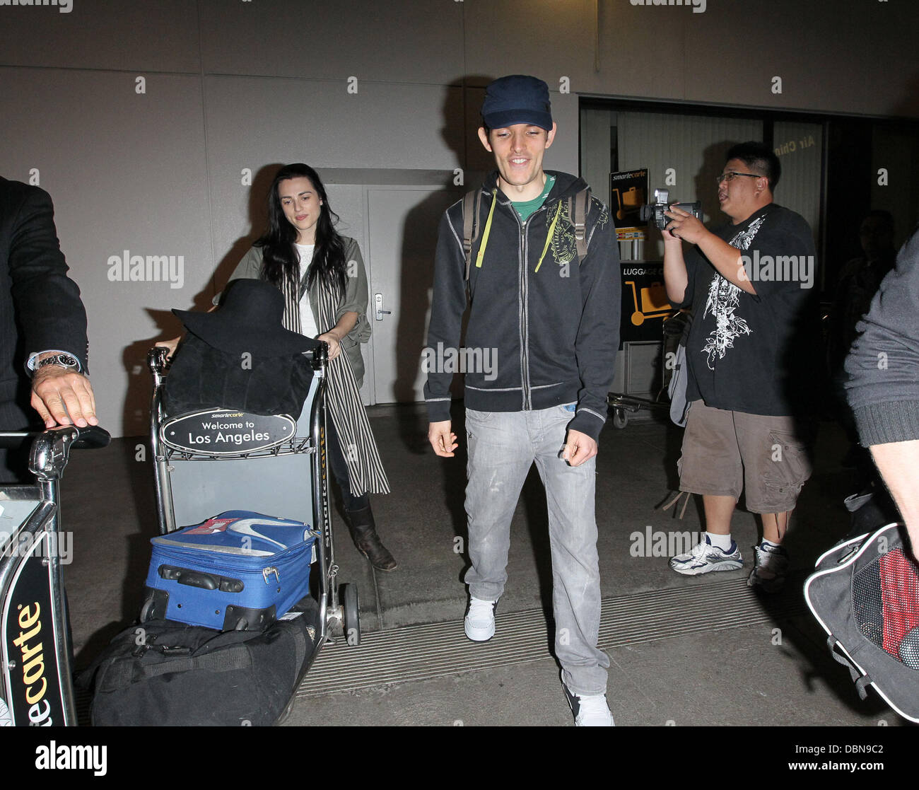 Katie McGrath and Colin Morgan The stars of international smash hit BBC television show 'Merlin' arrive at LAX on a flight from London Heathrow which was delayed over 4 hours from its scheduled arrival time. Los Angeles, California - 24.07.11 Stock Photo