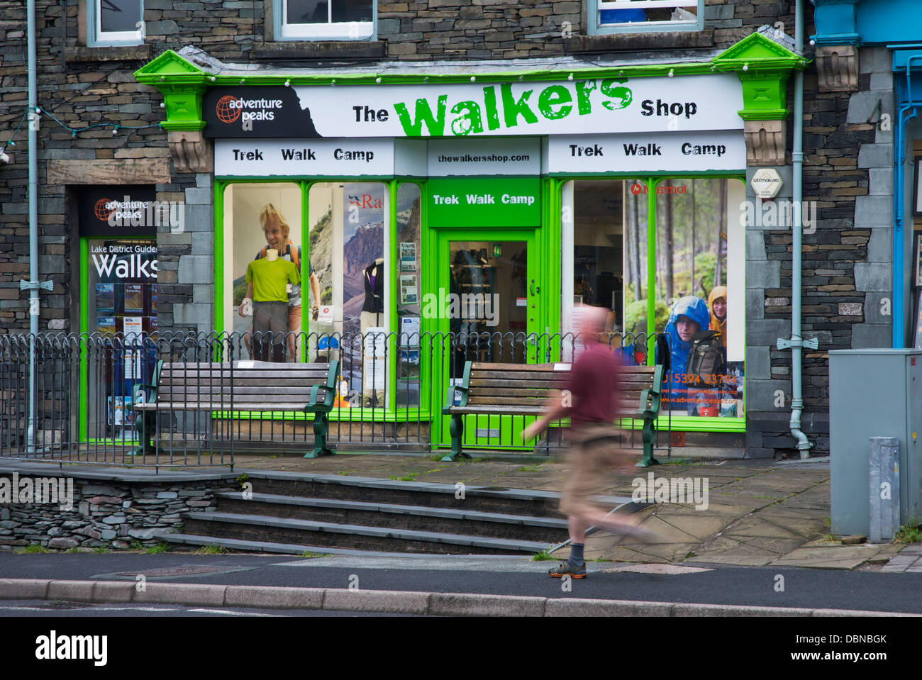Man walking past the Walkers Shop, in Ambleside, Lake District National
