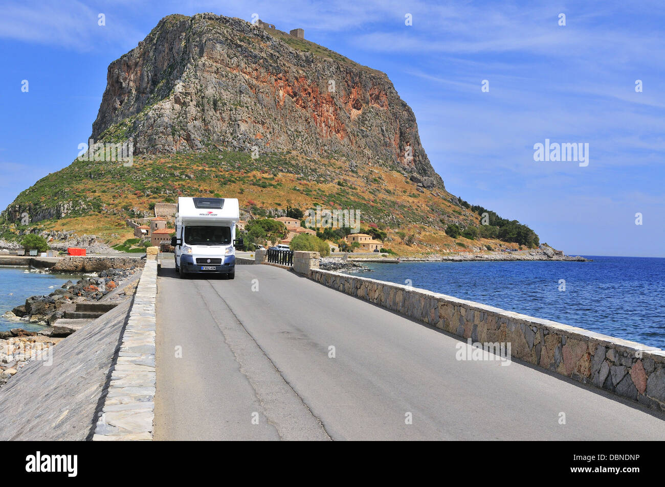 Motorhome driving across the causeway from Monemvasia to the mainland  Peloponnese, Greece Stock Photo