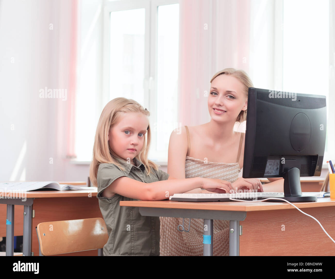 teacher explains the task schoolgirl at the computer Stock Photo - Alamy
