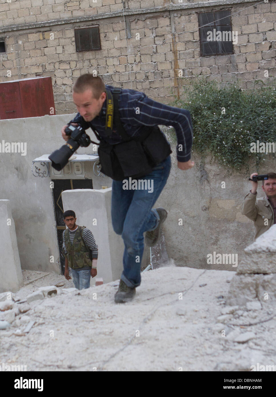 November 2, 2012 - Aleppo, Syria: A journalist runs past a sniper in Karm Al Jabal. Stock Photo