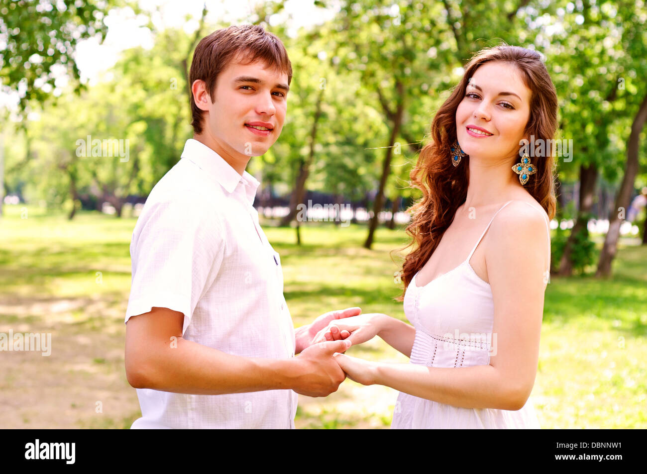 couple holding hands in the park Stock Photo - Alamy