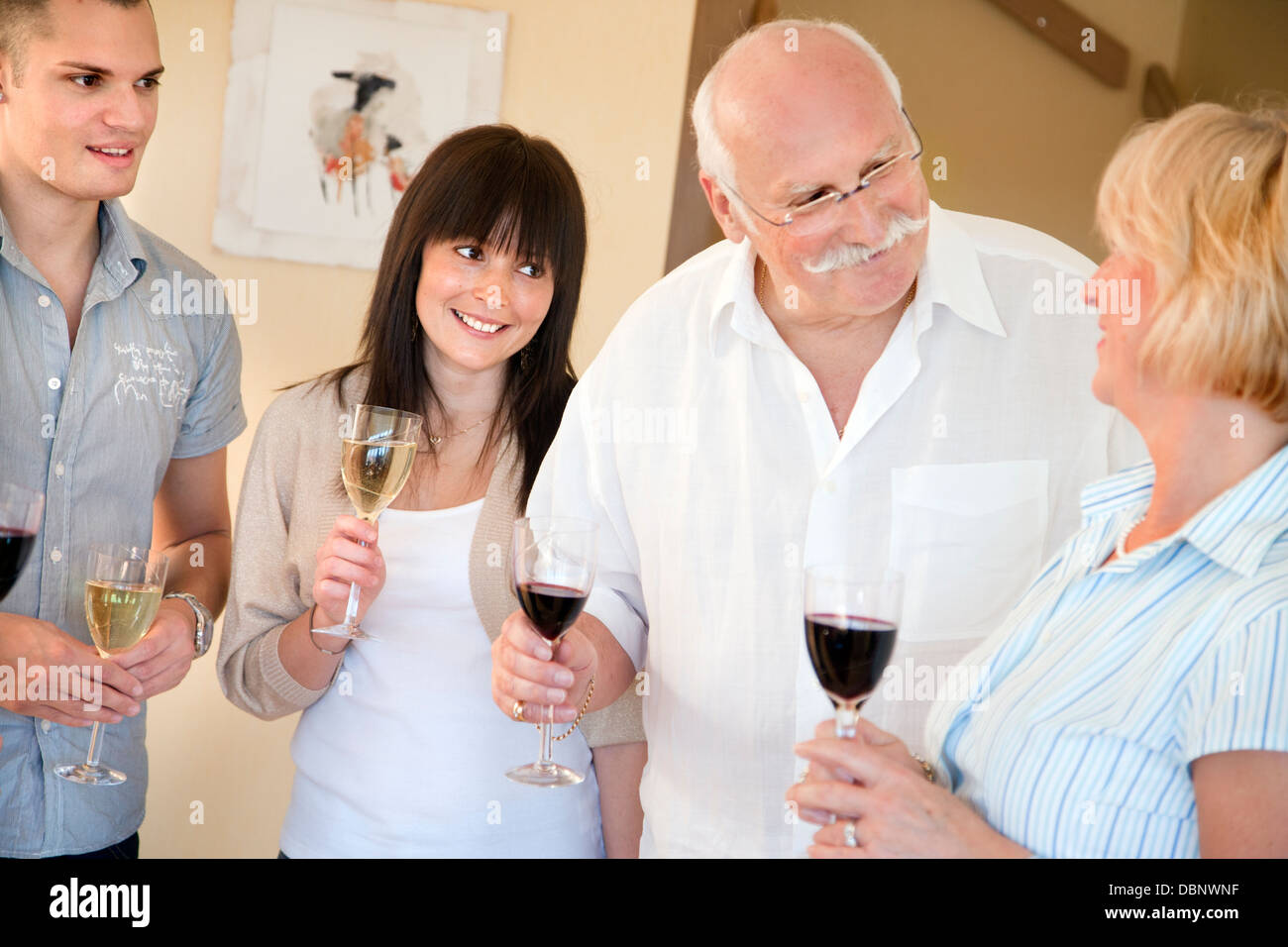 Four people toasting with wine Stock Photo