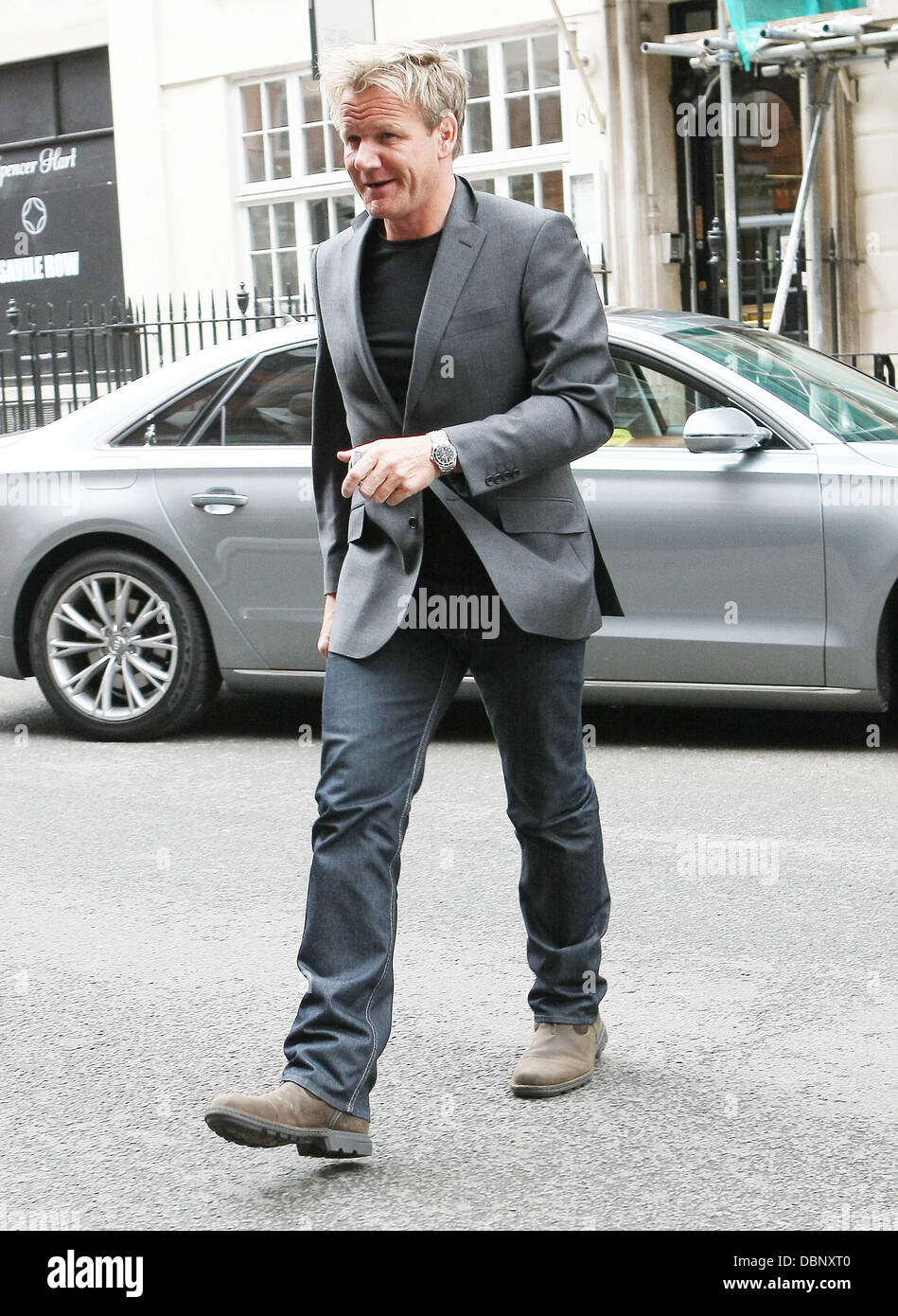 Celebrity chef Gordon Ramsay leaving Claridge's wearing a grey suit jacket with jeans London