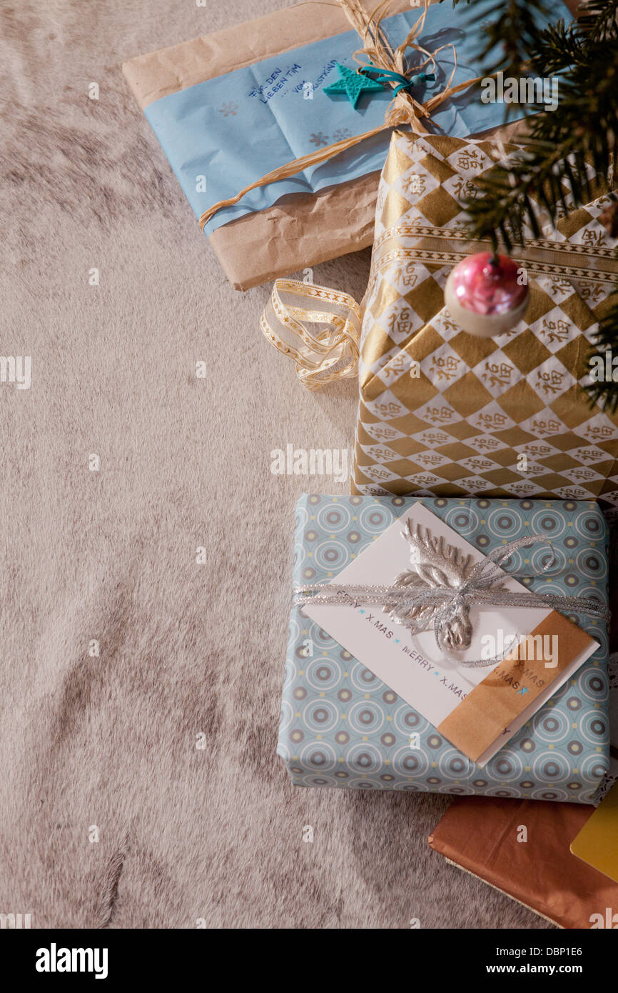 Gift boxes placed under Christmas tree, Munich, Bavaria, Germany Stock