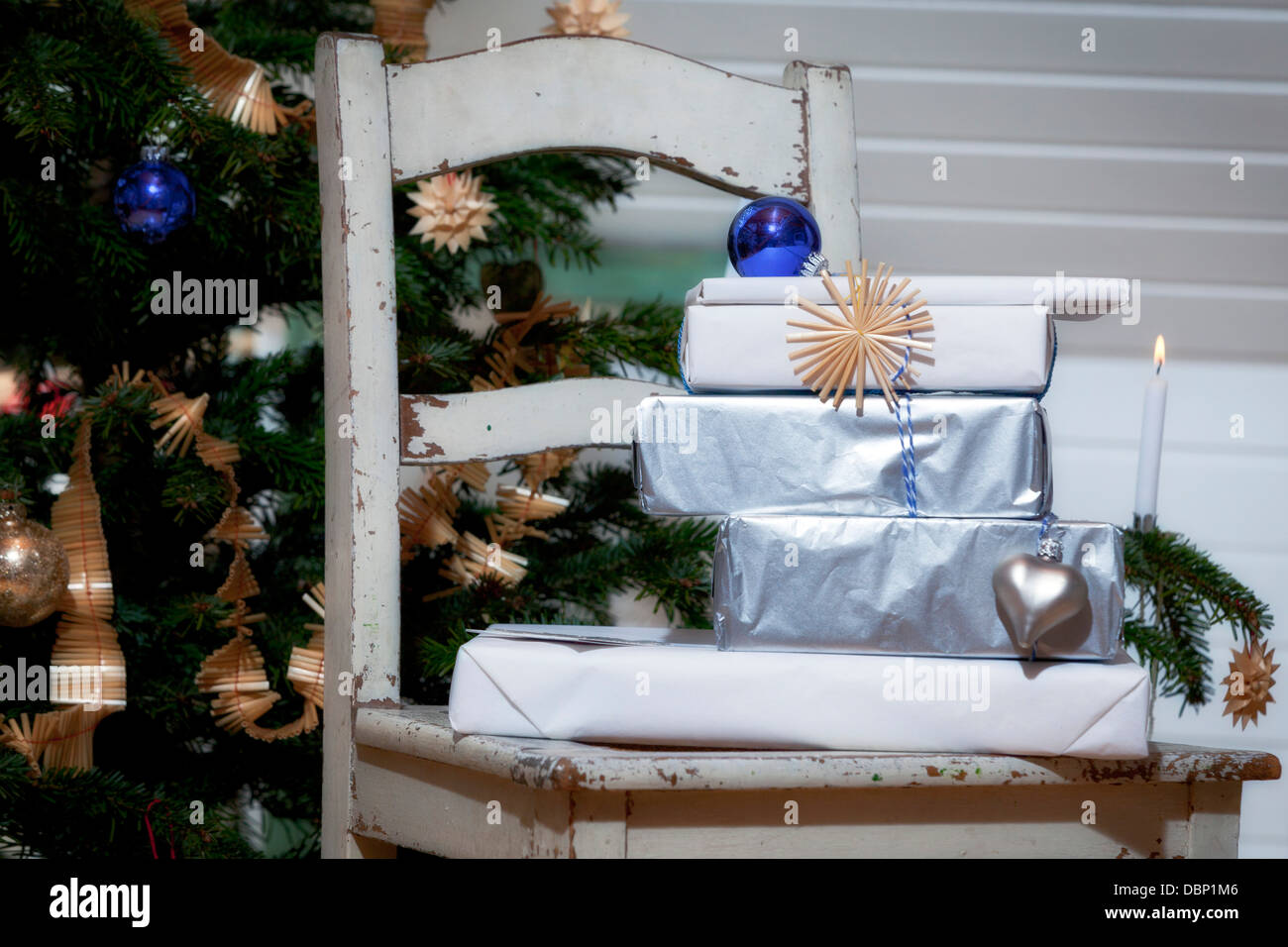 Gift boxes on a chair in front of Christmas tree, Munich, Bavaria