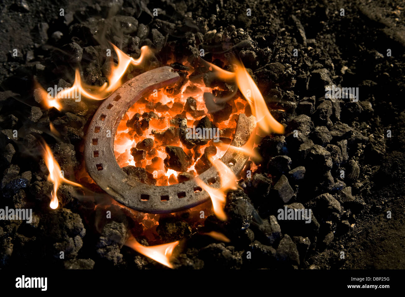 Horseshoe lying on burning coal, Landshut, Bavaria, Germany Stock Photo