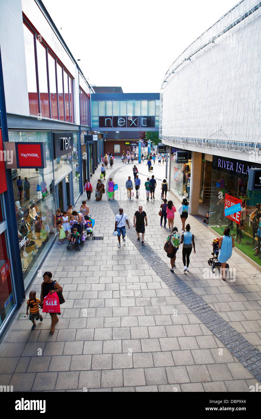 Consumers walking thru a pedestrian shopping center / centre / mall Stock Photo