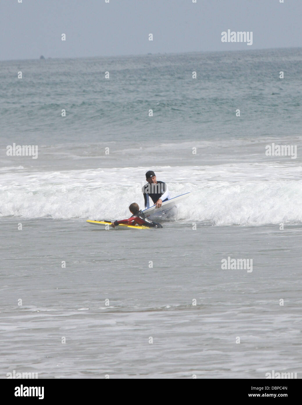 David Beckham  bodyboarding with his son Cruise on Malibu Beach  Los Angeles, California - 13.08.11 Stock Photo