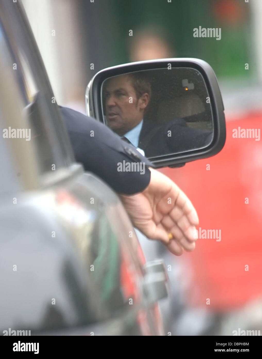 Shane Warne smoking a cigarette out of the window of his car while heading  to the Oval London, England - 18.08.11 Stock Photo