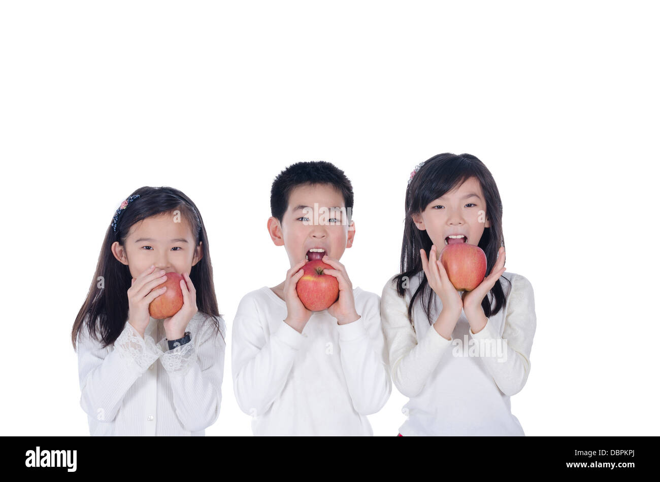 Three cute children eating an apples Stock Photo Alamy