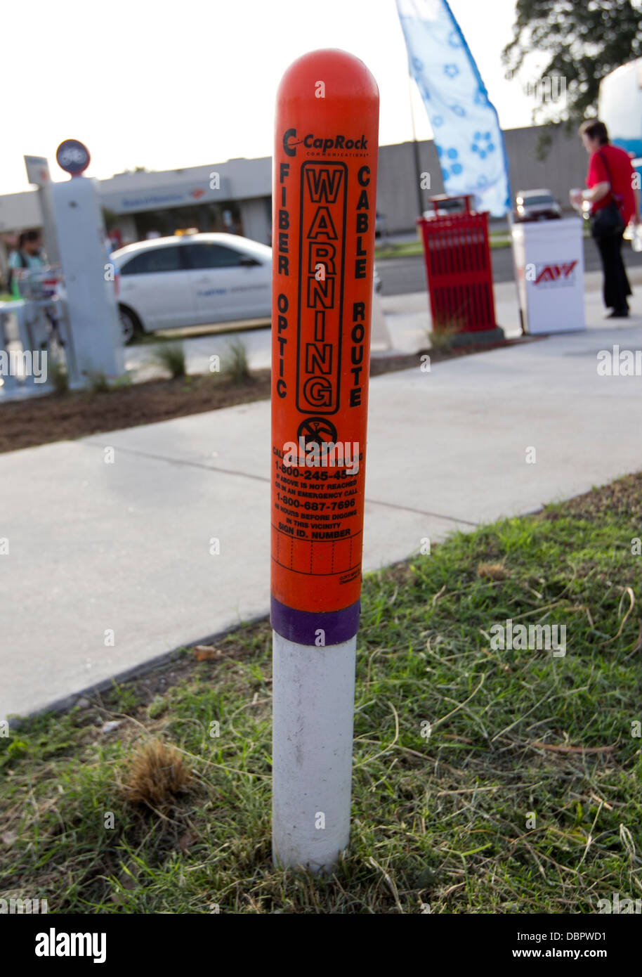 Warning cone alerting workers of buried fiber optic cables on street in Austin, Texas. Stock Photo