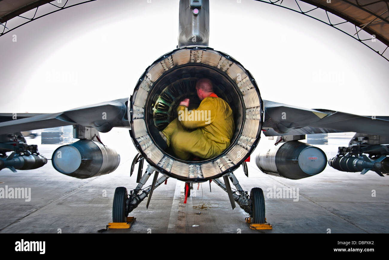 US Air Force Senior Airman Nate Hall conducts a post-flight inspection on an F-16 Fighting Falcon aircraft July 5, 2013 at Kandahar Airfield, Afghanistan. Stock Photo