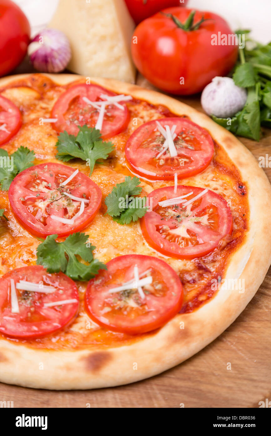 hot pizza with garnish and ingredients Stock Photo Alamy