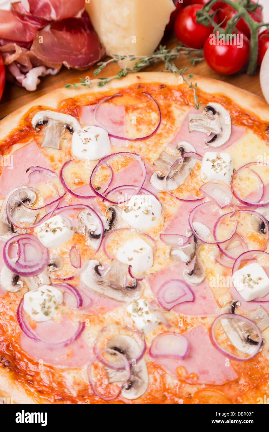 hot pizza with garnish and ingredients Stock Photo Alamy