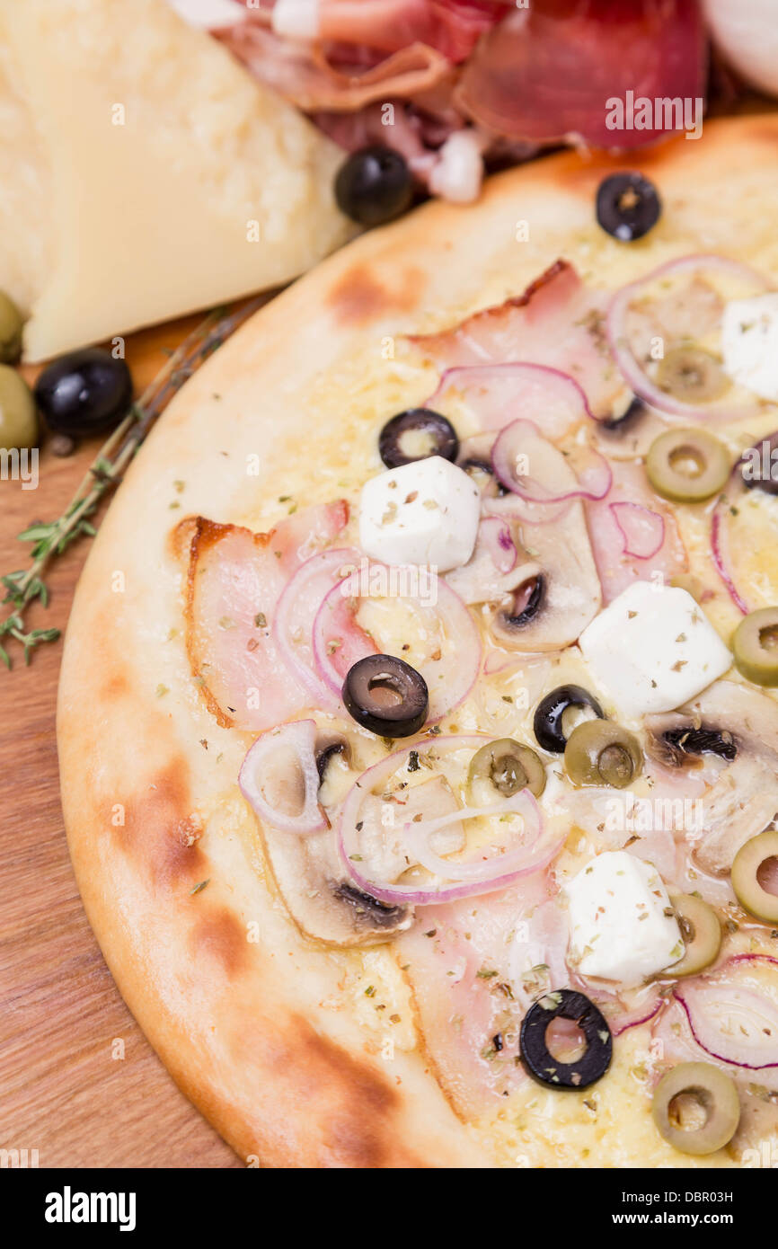 hot pizza with garnish and ingredients Stock Photo Alamy