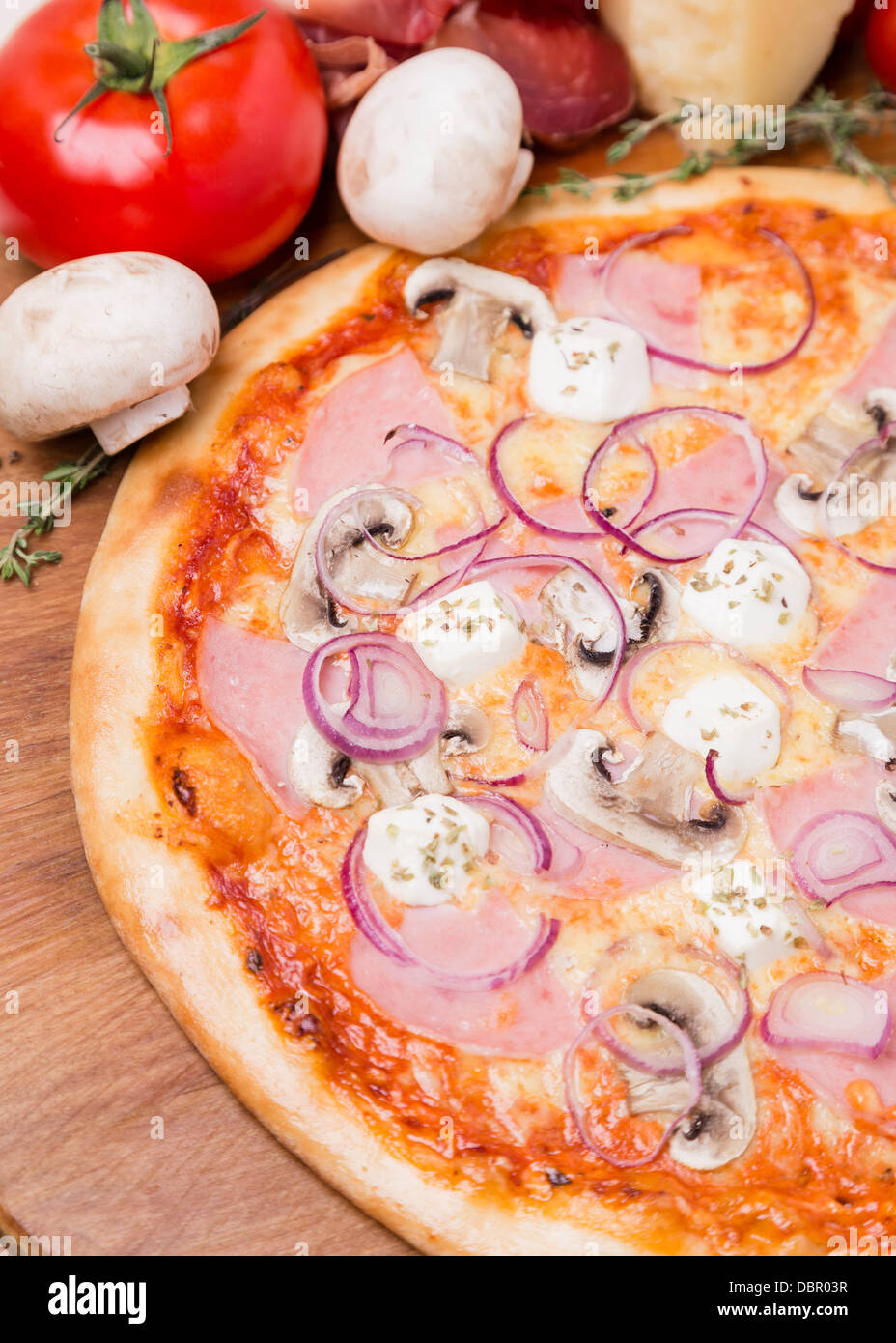 hot pizza with garnish and ingredients Stock Photo Alamy