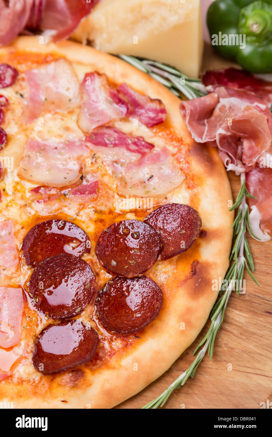 hot pizza with garnish and ingredients Stock Photo Alamy