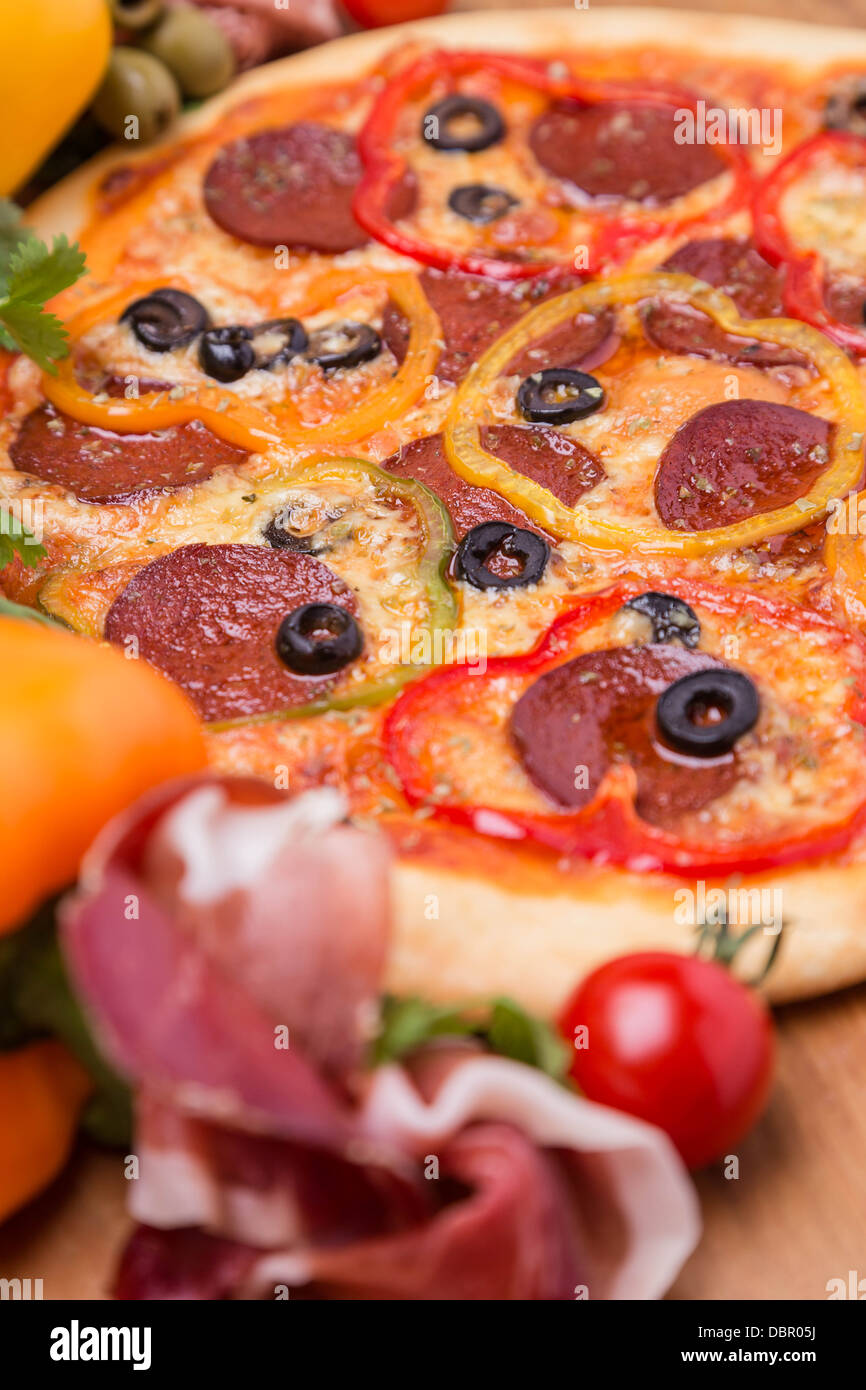 hot pizza with garnish and ingredients Stock Photo Alamy
